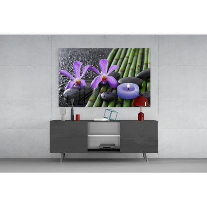 Purple orchid glass wall art with bamboo, stones, and blue candle