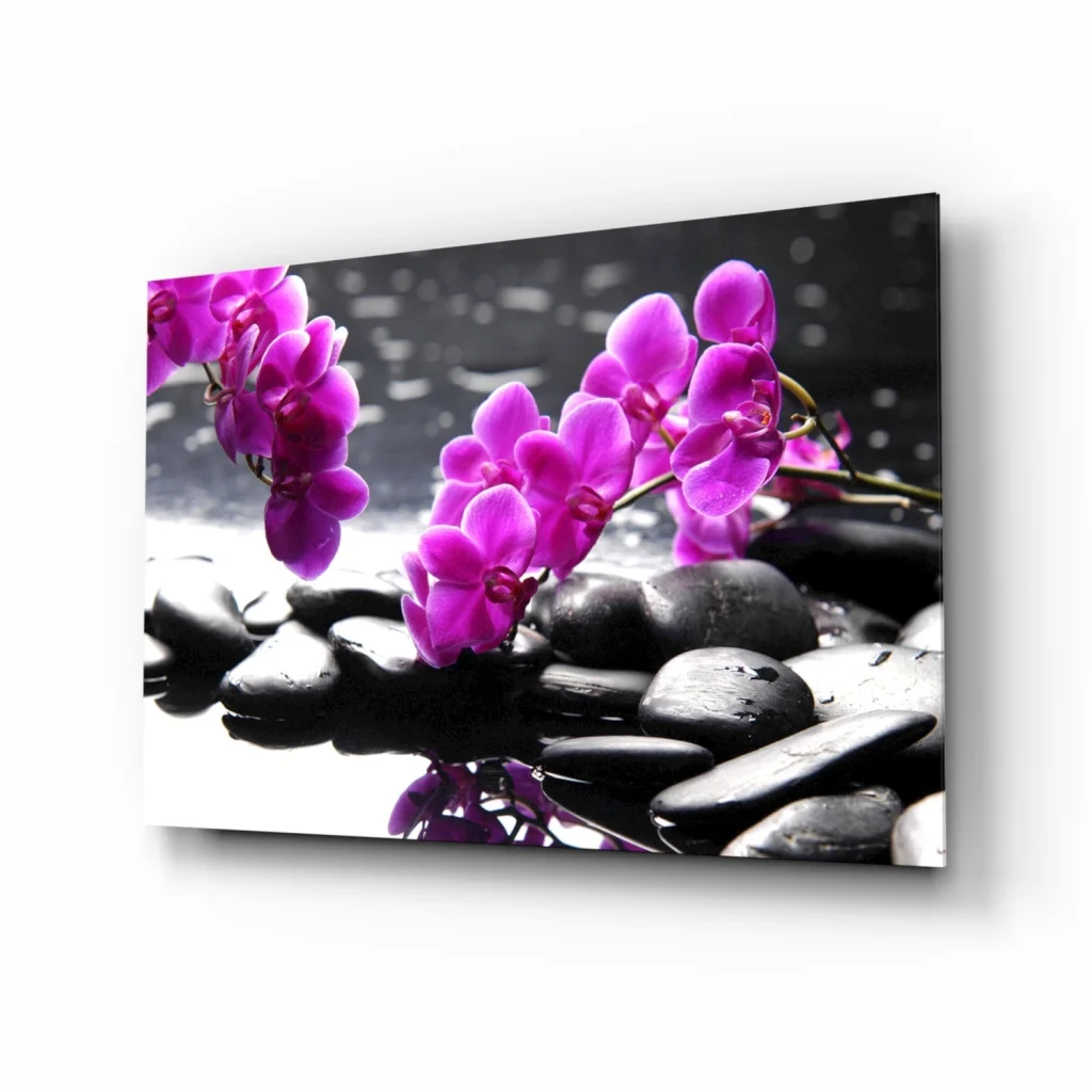 Vibrant purple orchids on black stones in glass wall art print