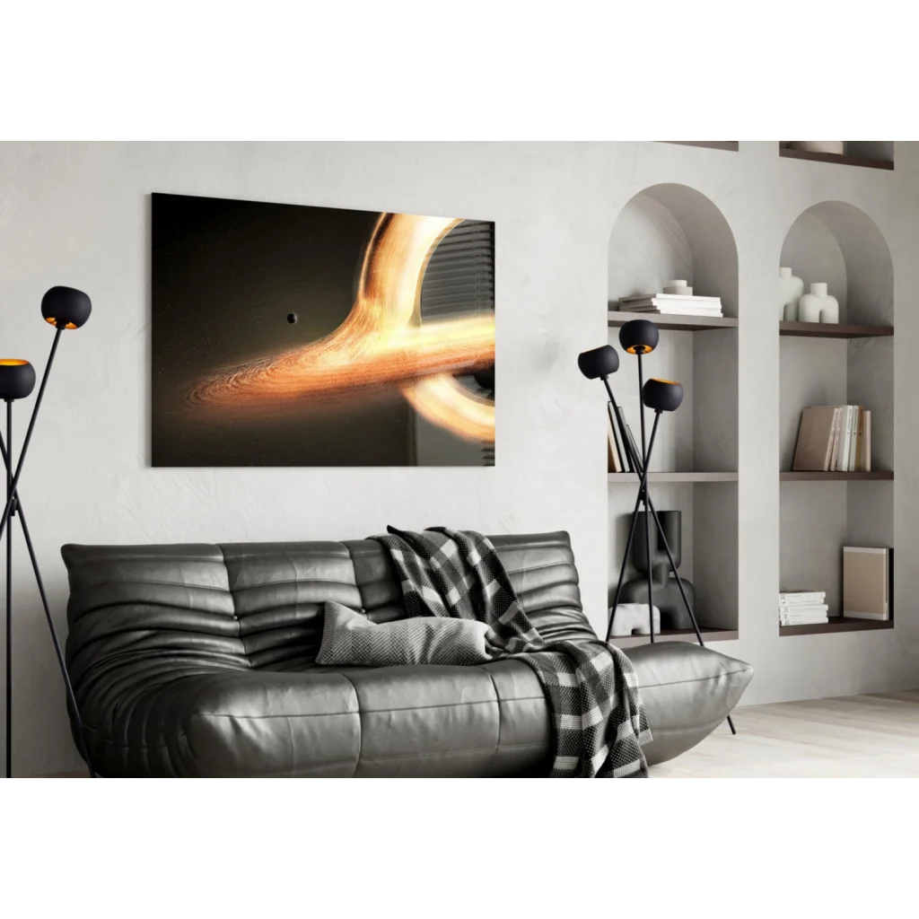 Black leather sofa with plaid throw and cosmic black hole wall art