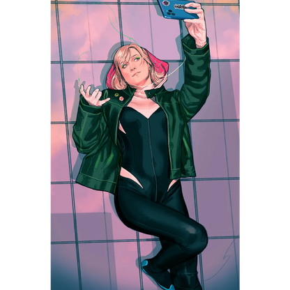Blonde woman with pink-tipped hair in black bodysuit and dark green jacket taking a selfie with a blue phone