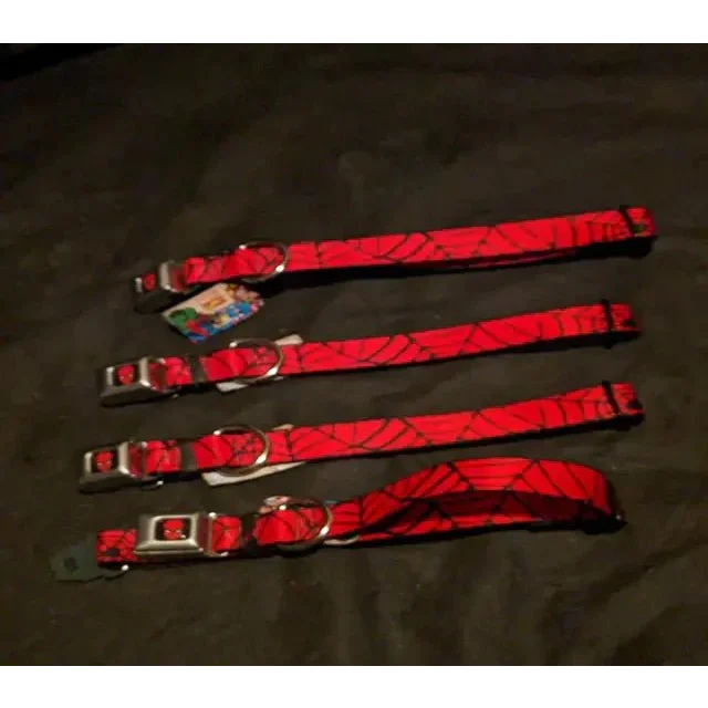 Four red Spiderman buckle collars with black spiderweb patterns and silver buckles