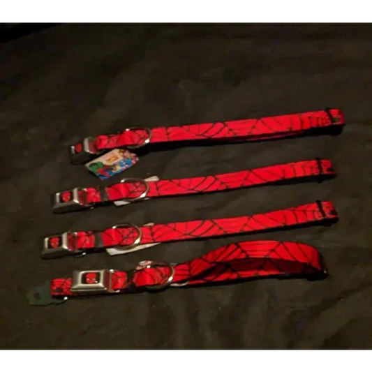 Four red Spiderman buckle collars with black spiderweb patterns and silver buckles
