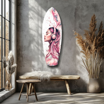 Oval glass wall art featuring pink-haired woman with headphones displayed above wooden bench in minimalist room with pampas grass decor.