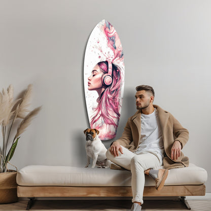 Man sitting on beige sofa beside oval glass wall art featuring pink-haired woman with headphones and watercolor effects.