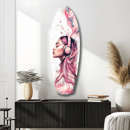 Oval glass wall art featuring a pink-haired woman wearing headphones against a watercolor abstract background, displayed above a black ribbed cabinet.