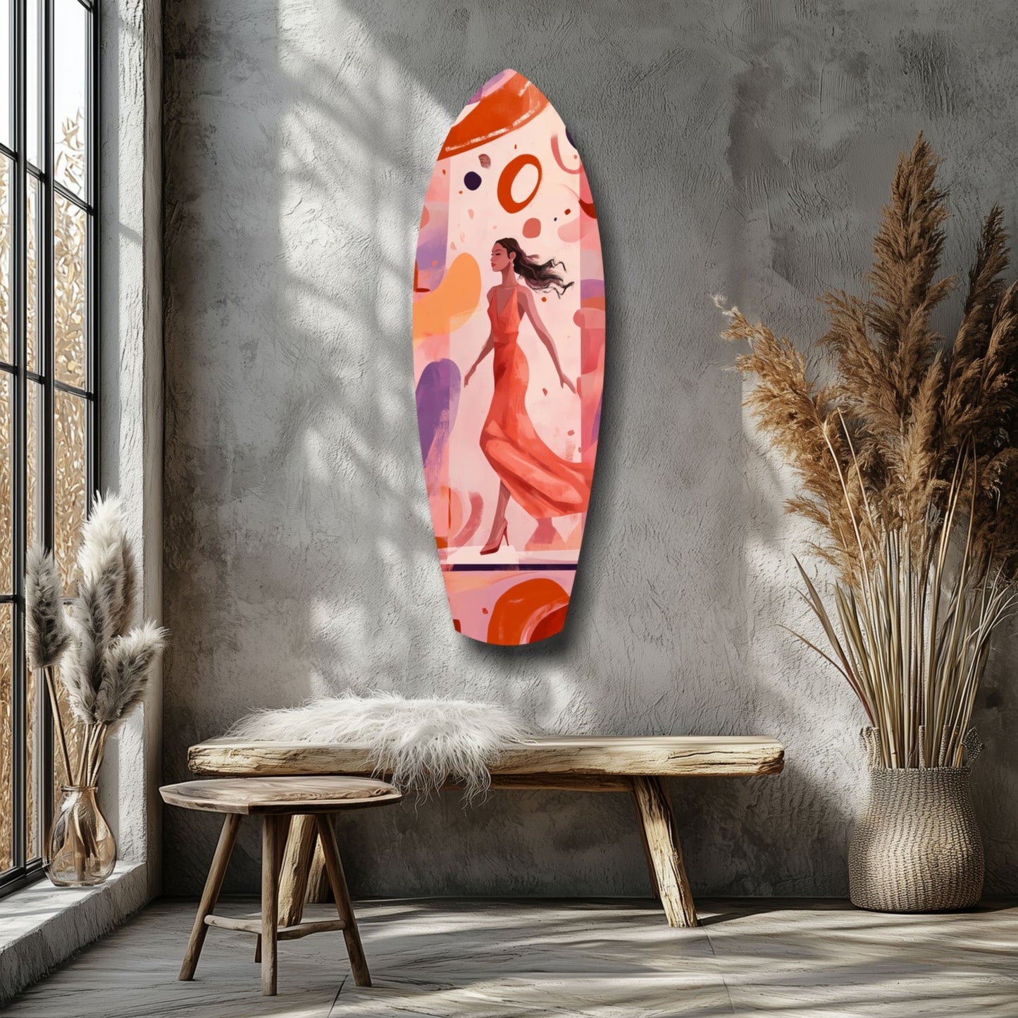 Elongated oval glass wall art with abstract illustration of woman in red dress against pink and orange gradient background, displayed on gray textured wall above wooden bench.