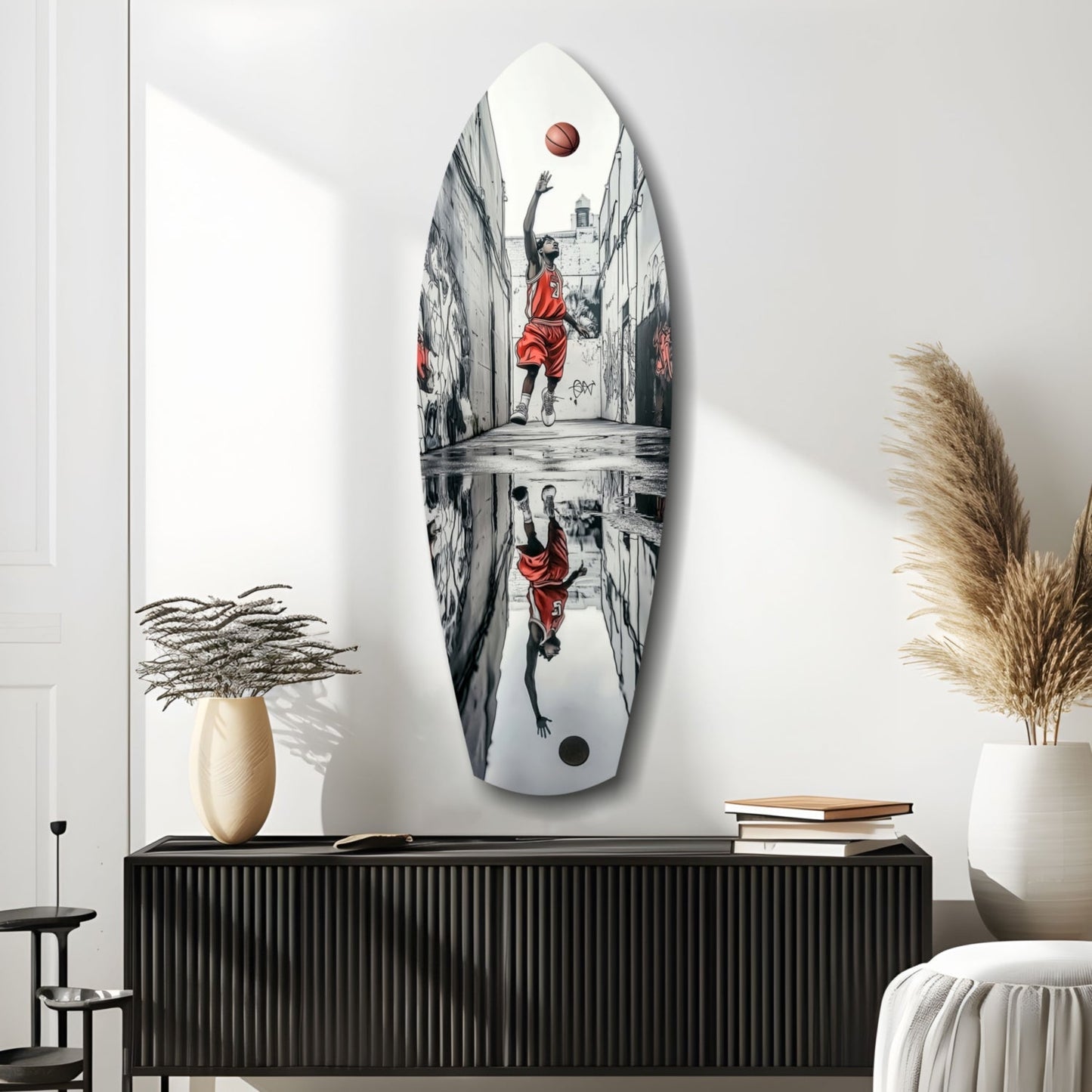 Oval glass wall art featuring black and white street scene with figure in red basketball jersey shooting ball, displayed above black cabinet in modern interior.