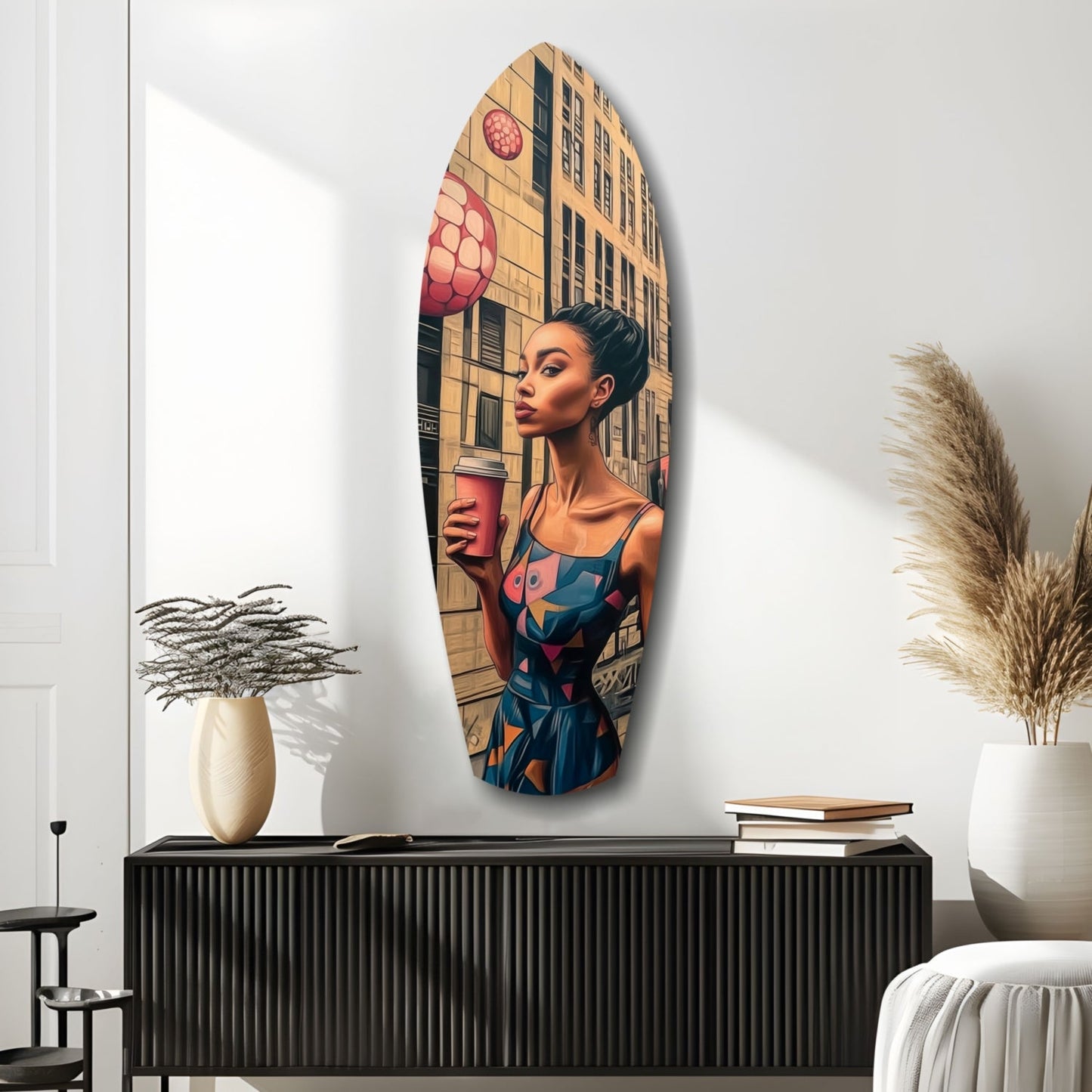 Oval glass wall art depicting a woman in colorful dress holding coffee, with urban building and pink lantern backdrop, displayed above black cabinet.
