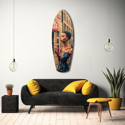 Oval glass wall art featuring a woman in a blue dress holding a pink cup against an urban building backdrop, displayed above a black sofa with yellow pillows.