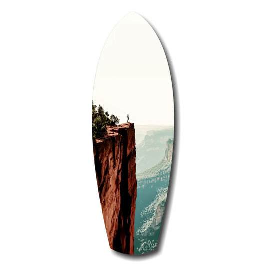 Oval glass wall art displaying a lone figure standing atop a red rock cliff overlooking a misty canyon valley below.