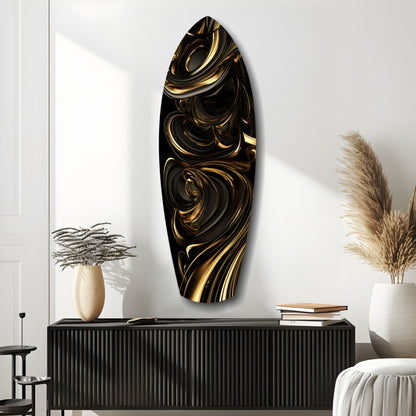 Black and gold swirled glass wall art displayed vertically above a ribbed black console table in a minimalist interior.