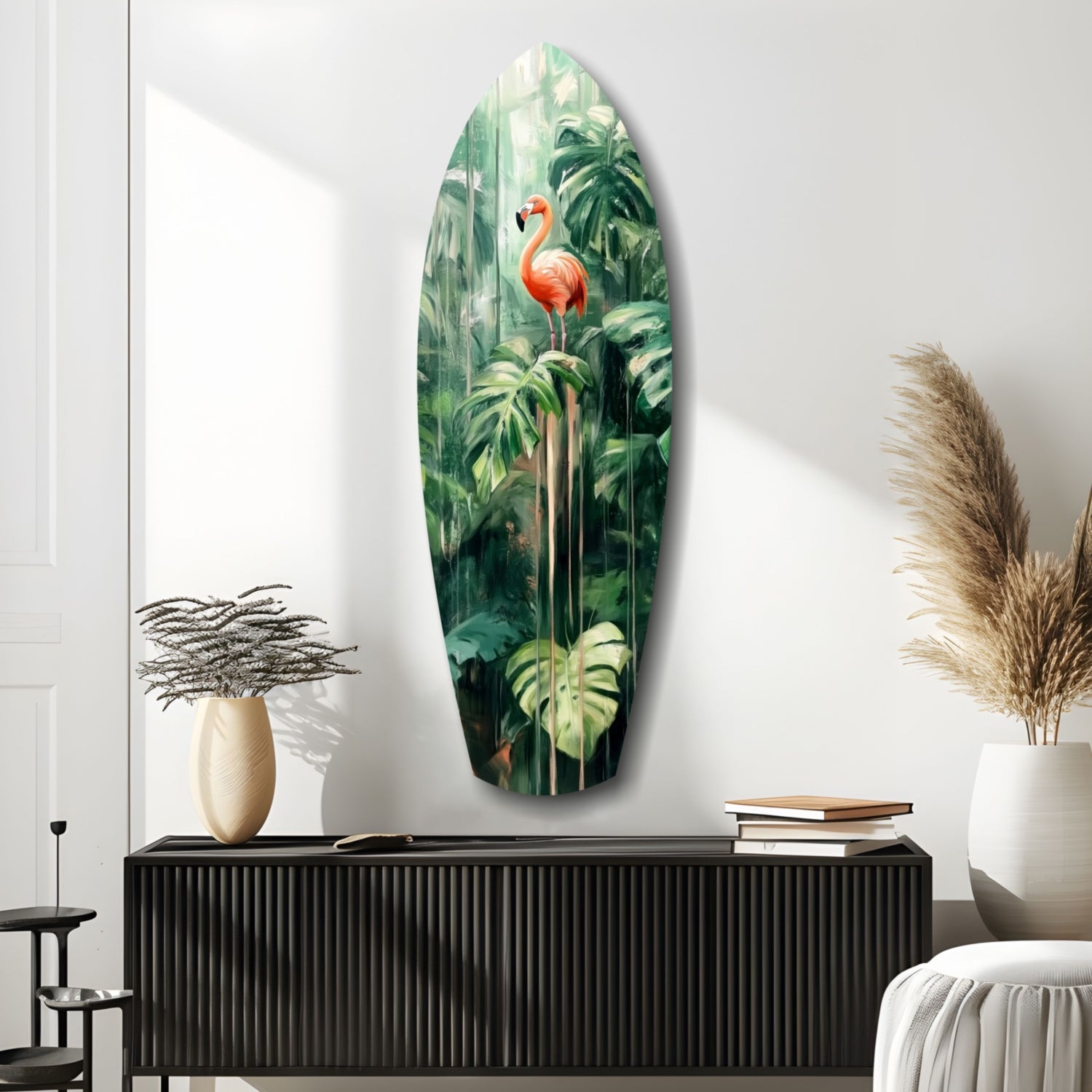 Oval glass wall art depicting a coral flamingo among lush green tropical foliage, displayed above a black ribbed cabinet.