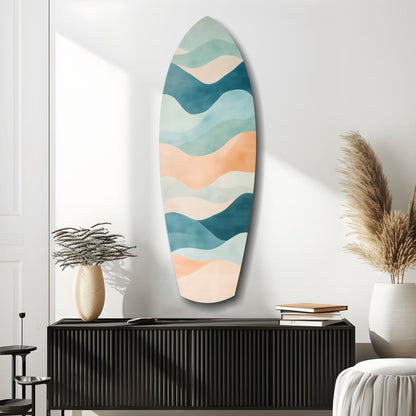 Oval wall art with layered wavy stripes in teal, cream, and peach tones displayed above black cabinet in modern interior setting.