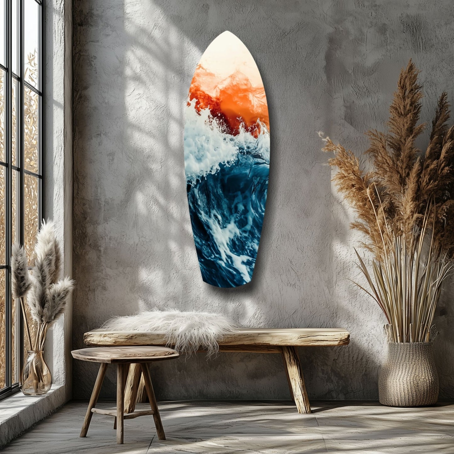 Surfboard-shaped glass wall art displaying layered orange, white, and deep blue ocean wave design hung in minimalist room with wooden bench and dried pampas grass.