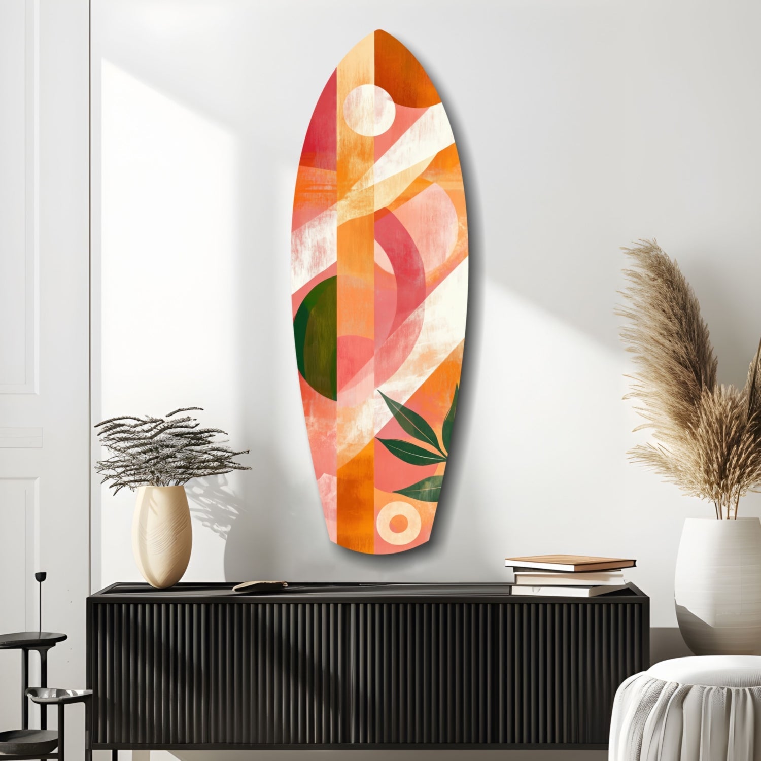 Colorful glass wall art in warm tones of orange, coral, and cream displayed above a black ribbed cabinet in a modern interior setting.