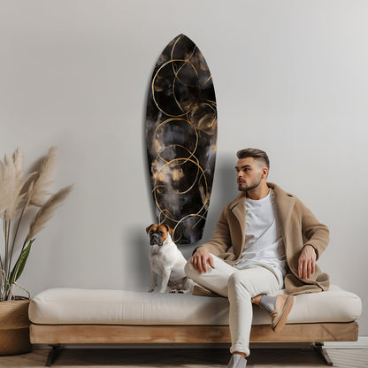 Man in beige cardigan sitting on cream bench beside brown dog, black glass wall art with golden circles above.
