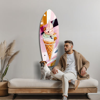Man and dog sitting on cream sofa beside tall oval glass wall art featuring colorful stacked ice cream cone illustration.