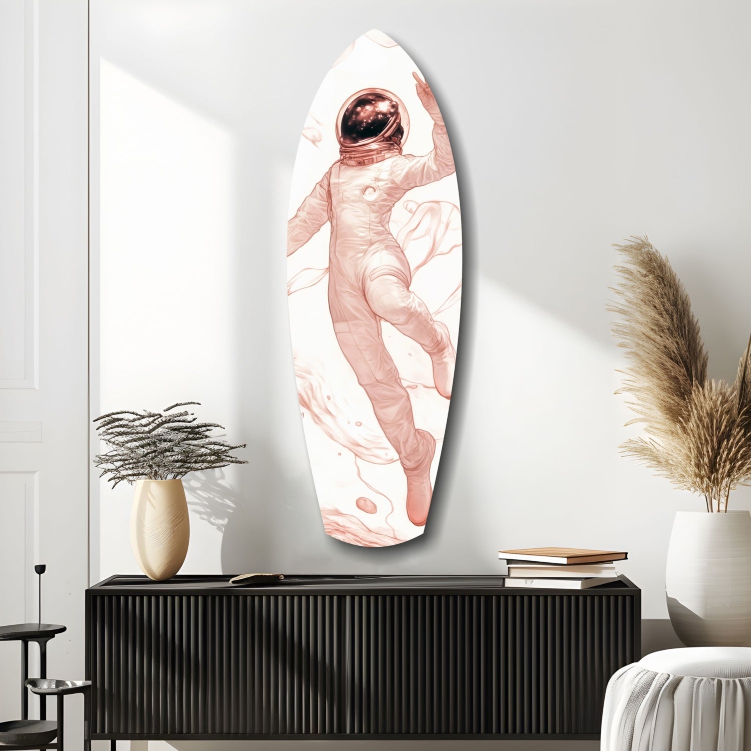 Oval glass wall art depicting a pink-toned astronaut floating in white space, displayed above a black ribbed cabinet in a minimalist room setting.