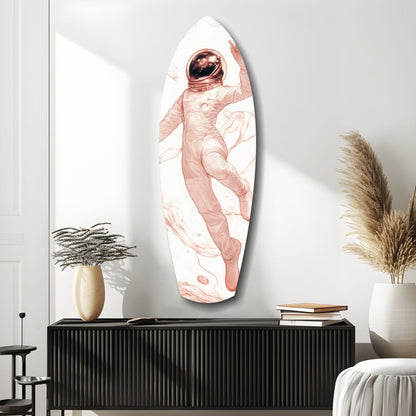 Oval glass wall art depicting a pink-toned astronaut floating in white space, displayed above a black ribbed cabinet in a minimalist room setting.