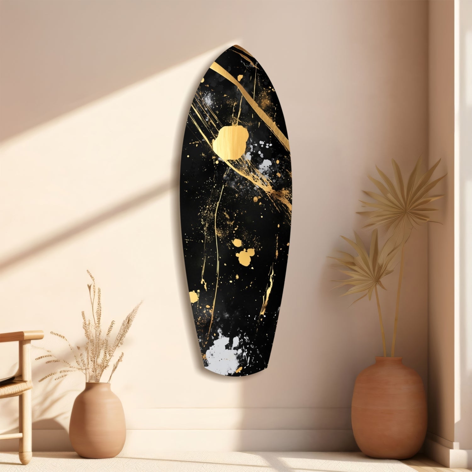 Black and gold splattered oval wall art displayed above terracotta vases with dried grasses in minimalist interior setting.