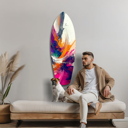 Man and dog sitting on cream sofa beneath colorful abstract glass art featuring pink, orange, blue and white paint strokes.