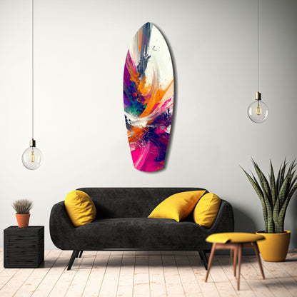 Colorful abstract glass wall art with vibrant pink, orange, blue, and purple paint swirls displayed above black sofa in modern living room.