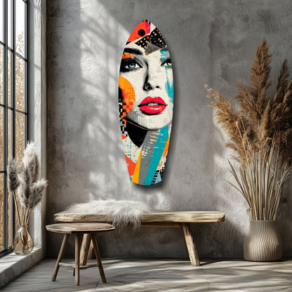 Colorful pop art glass wall sculpture of a woman's face with red lips and geometric shapes displayed above a wooden bench in a minimalist interior.