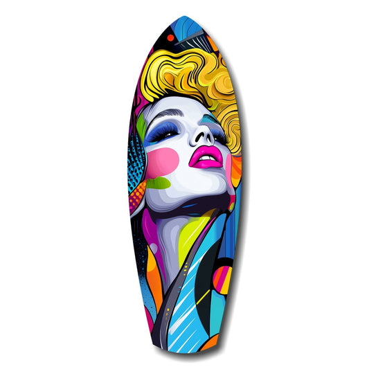 Colorful pop art surfboard featuring a stylized woman's face with blonde hair, vibrant geometric patterns in pink, yellow, blue, and orange throughout.
