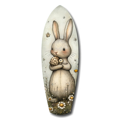 White rabbit holding a small turtle, surrounded by daisies and insects on an oval glass wall art panel.