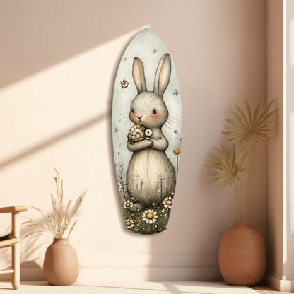 Cute rabbit glass wall art displayed on a beige wall between two terracotta vases with dried grasses, featuring a bunny holding a turtle surrounded by daisies and insects.