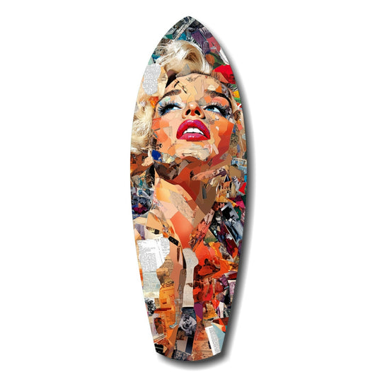 Surfboard-shaped glass art featuring a glamorous portrait with blonde hair and red lips, composed of colorful magazine clippings and newspaper fragments in orange, red, and multi-color tones.