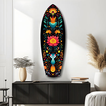 Colorful folk art glass wall panel with orange flowers, teal fox and rabbit figures on black background, displayed above black cabinet in modern interior.