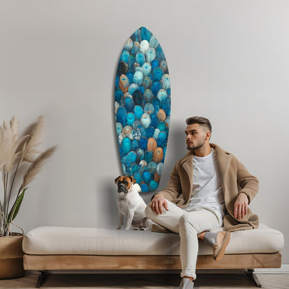 Man and dog sitting on beige bench below oval blue glass wall art with colorful circular patterns in coastal living room setting.