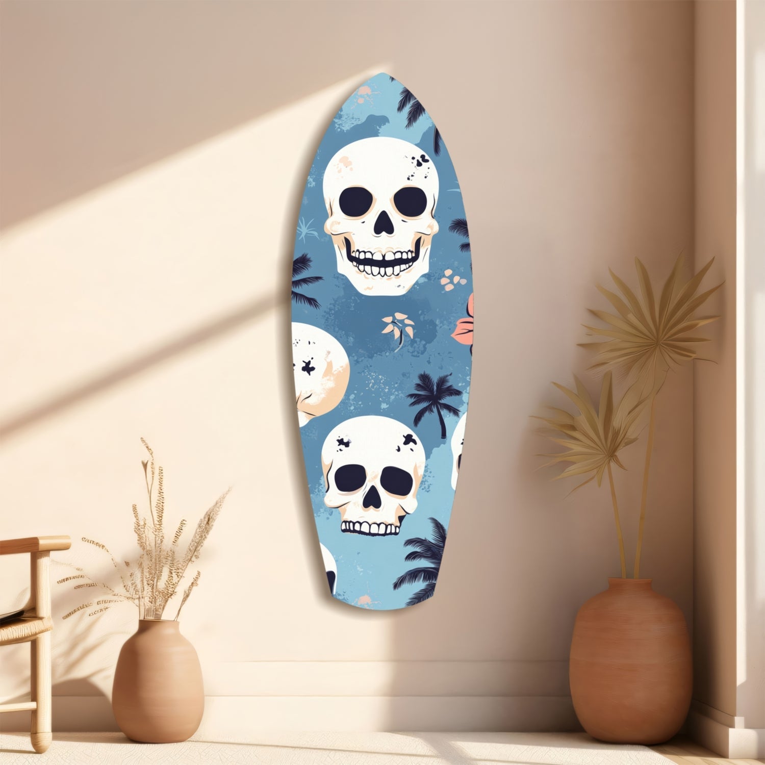 Surfboard-shaped glass wall art with blue background, white skulls, and tropical palm leaf patterns displayed on cream wall beside decorative vases.