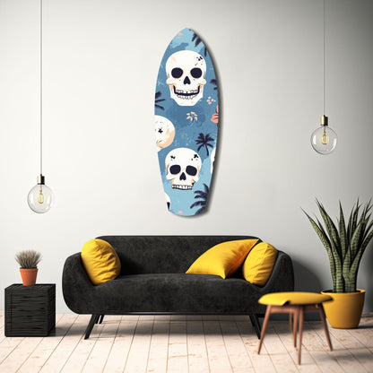 Oval glass wall art featuring white skulls and tropical palm leaves on blue background, displayed above black sofa with yellow pillows in modern living room setting.