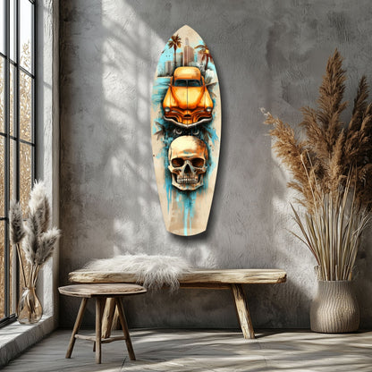 Surfboard-shaped glass wall art featuring an orange vintage car above a skull with blue watercolor drips, displayed in a minimalist room with wooden bench and dried plants.