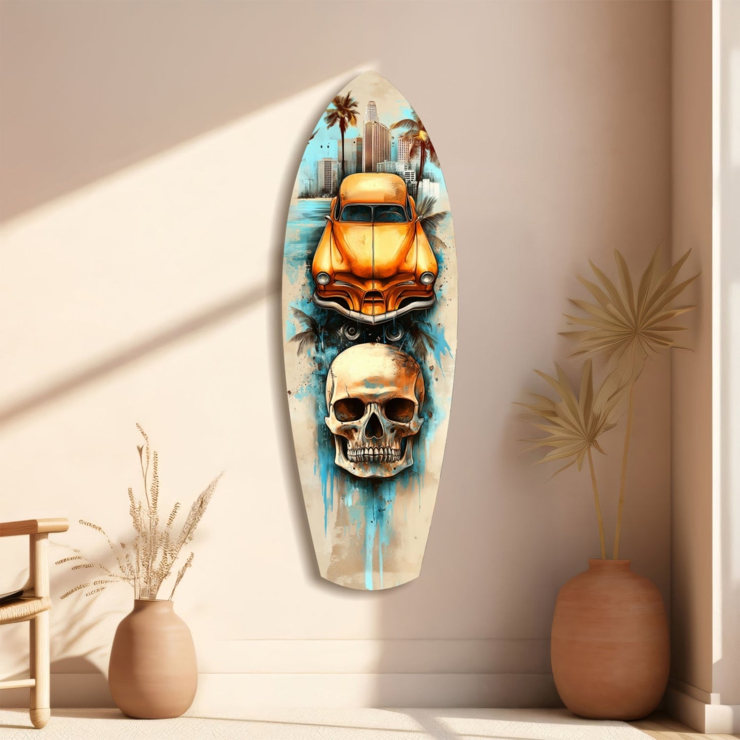 Surfboard-shaped wall art displaying orange vintage car, skull, and palm trees against cream wall with dried plants beside it.