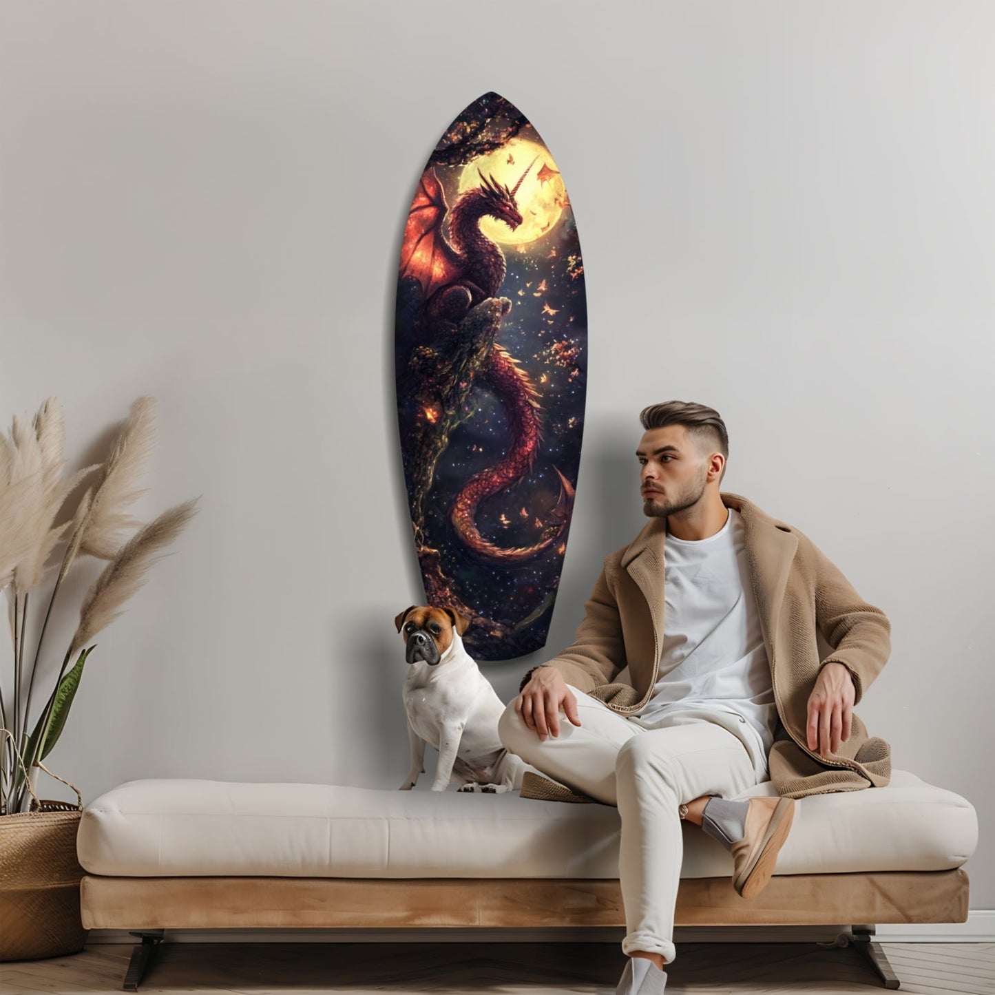 Man and dog sitting on cream bench below oval glass wall art depicting fiery dragon and moon against dark starry background.
