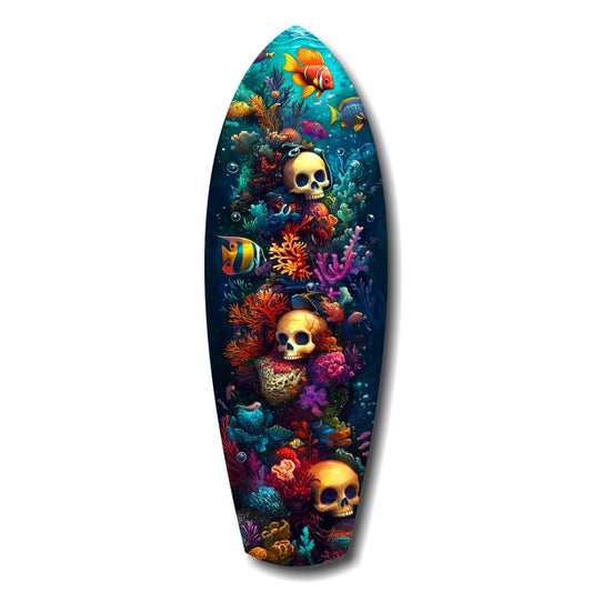 Surfboard-shaped glass art featuring three golden skulls surrounded by colorful coral, tropical fish, and sea life against a dark blue gradient background.