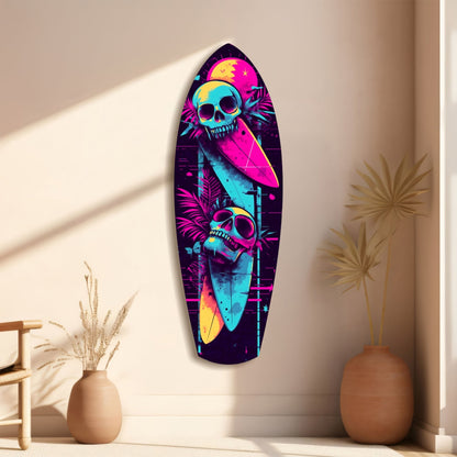 Neon surfboard glass wall art with vibrant magenta, cyan, and yellow skulls and tropical elements displayed on a beige wall between decorative vases.