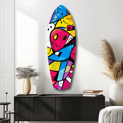 Colorful geometric glass wall art featuring bold pink, blue, yellow, and black abstract design displayed above black cabinet in modern room setting.