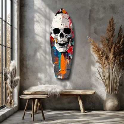 Colorful street art skull glass wall art displayed above wooden bench in minimalist room with pampas grass decor.