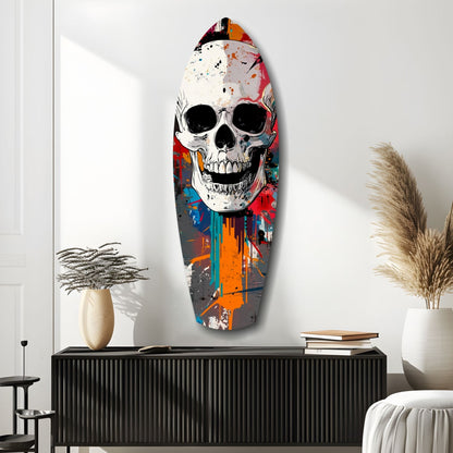 Colorful street art skull glass wall art mounted above black cabinet with decorative vases and pampas grass in minimalist room setting.