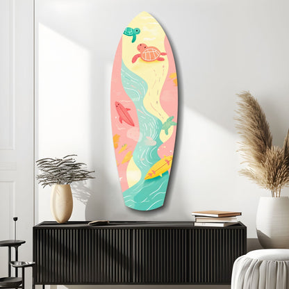 Surfboard-shaped wall art with colorful sea turtles, waves, and beach scenes in yellow, pink, and turquoise, displayed above a black cabinet in a minimalist bedroom.