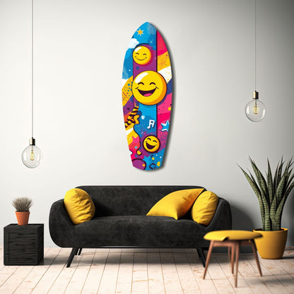 Colorful smiley face glass wall art featuring yellow emoji and musical notes on blue, pink, and purple background, displayed above black sofa in modern living room.