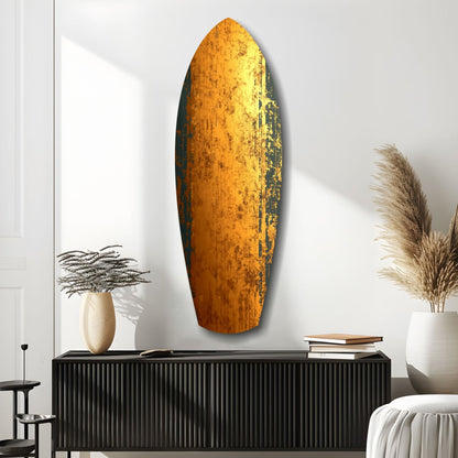 Oval golden glass wall art with weathered texture displayed above black cabinet in minimalist room setting.
