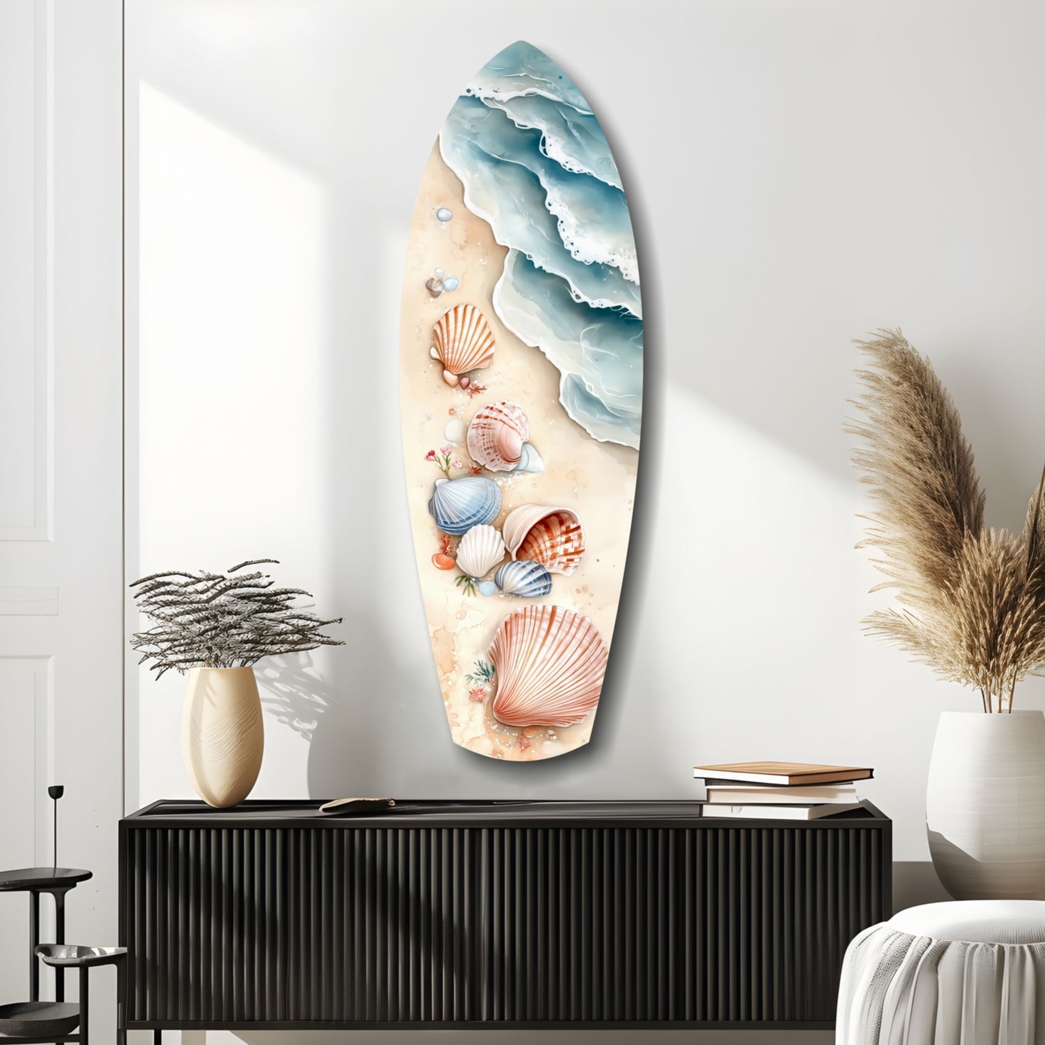 Surfboard-shaped glass wall art featuring layered ocean waves in blue tones and seashells in coral and cream colors on sandy background, displayed above black cabinet.