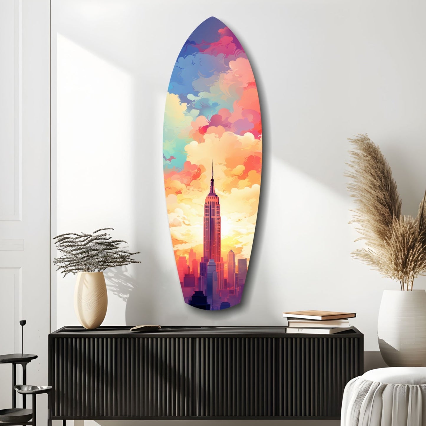 Colorful surfboard-shaped glass art featuring Empire State Building silhouette against vibrant rainbow sky, displayed on black dresser in modern interior.