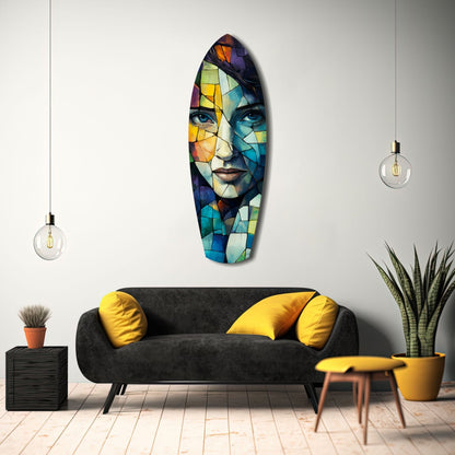 Colorful stained glass portrait hanging above black sofa with yellow pillows in modern living room interior.