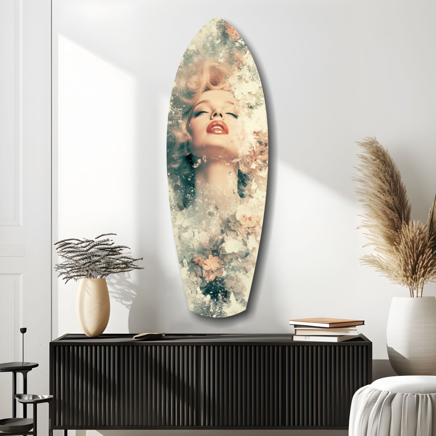 Oval glass wall art featuring a portrait of a woman with blonde hair and red lips blended with soft floral and textured overlays, displayed above a black ribbed cabinet.